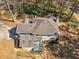 An aerial shot showcasing the home's roof, siding, deck, and surrounding landscape at 105 Lakeview Ln, Stockbridge, GA 30281