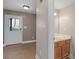 View of the bathroom featuring a light wood vanity with a white countertop and flooring, and a white door at 105 Lakeview Ln, Stockbridge, GA 30281