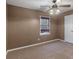 Neutral bedroom featuring plush carpeting, a ceiling fan, and natural lighting from one window at 105 Lakeview Ln, Stockbridge, GA 30281