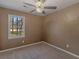 Neutral bedroom featuring plush carpeting, a ceiling fan, and natural lighting from one window at 105 Lakeview Ln, Stockbridge, GA 30281