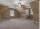 Spacious bedroom with plush carpeting, a ceiling fan, and a window providing natural light at 105 Lakeview Ln, Stockbridge, GA 30281