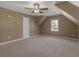 Carpeted bedroom with neutral walls, angled ceiling, a ceiling fan, and a window at 105 Lakeview Ln, Stockbridge, GA 30281