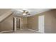 Large carpeted bedroom showing angled ceilings, white doors and trim, and neutral walls at 105 Lakeview Ln, Stockbridge, GA 30281