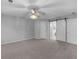 Bedroom featuring carpeted floors, a ceiling fan, and a doorway to an ensuite at 105 Lakeview Ln, Stockbridge, GA 30281