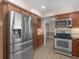 Updated kitchen showcasing a stainless steel refrigerator, oven, and wood cabinets at 105 Lakeview Ln, Stockbridge, GA 30281