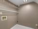 Neutral-toned laundry area featuring wire shelving, connections for the machines and basic lighting at 105 Lakeview Ln, Stockbridge, GA 30281