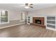 Bright living room with a fireplace flanked by white built-ins and large windows at 105 Lakeview Ln, Stockbridge, GA 30281