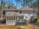 Expansive back of home featuring a sunroom, deck, and well-maintained landscaping at 105 Lakeview Ln, Stockbridge, GA 30281