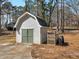 Exterior view of the shed, showcasing its vinyl siding and the surrounding yard at 105 Lakeview Ln, Stockbridge, GA 30281