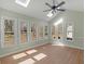 Light-filled sunroom features multiple windows, a ceiling fan, and vaulted ceilings at 105 Lakeview Ln, Stockbridge, GA 30281