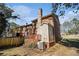 Back exterior of a brick house featuring a chimney and a deck at 5293 Oakridge Dr, Stone Mountain, GA 30083