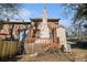 Exterior view of a brick home with a wooden deck and fenced backyard at 5293 Oakridge Dr, Stone Mountain, GA 30083