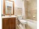 Bathroom featuring a wooden vanity, a shower with beige tile, and decorative tile accent at 5293 Oakridge Dr, Stone Mountain, GA 30083