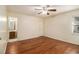 Bedroom with hardwood floors, ceiling fan, and access to bathroom at 5293 Oakridge Dr, Stone Mountain, GA 30083