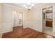 Well-lit dining room with wood floors and easy access to the kitchen and powder room at 5293 Oakridge Dr, Stone Mountain, GA 30083