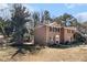 A lovely brick home with dark shutters and green foliage at 5293 Oakridge Dr, Stone Mountain, GA 30083