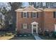 Two-story brick townhome with an inviting entrance and manicured landscaping at 5293 Oakridge Dr, Stone Mountain, GA 30083