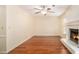 Spacious living room with hardwood floors, a fireplace, and neutral paint at 5293 Oakridge Dr, Stone Mountain, GA 30083