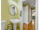 Bathroom with a white sink and mirror, with an open doorway at 231 Peachtree Ne Way, Atlanta, GA 30305