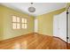 Bedroom with a large window, hardwood floors, and access to the home's hallway at 231 Peachtree Ne Way, Atlanta, GA 30305