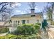 Classic brick home with well-maintained landscaping, a dark front door, and sidewalk access at 231 Peachtree Ne Way, Atlanta, GA 30305