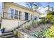 Inviting brick home featuring a black front door, black railings, and low maintenance yard at 231 Peachtree Ne Way, Atlanta, GA 30305
