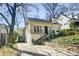 This brick home boasts a convenient driveway, a well-kept lawn, and charming architectural features at 231 Peachtree Ne Way, Atlanta, GA 30305