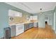 Bright, modern kitchen with stainless steel appliances, white cabinets, and hardwood floors at 231 Peachtree Ne Way, Atlanta, GA 30305