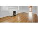 Cozy living room with hardwood floors, a white brick fireplace, and freshly painted walls at 231 Peachtree Ne Way, Atlanta, GA 30305