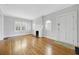 Bright living room with hardwood floors, white fireplace, and abundant natural light through windows at 231 Peachtree Ne Way, Atlanta, GA 30305
