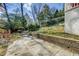 Hardscaped patio area surrounded by lush greenery at 231 Peachtree Ne Way, Atlanta, GA 30305
