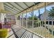 Relaxing screened porch featuring a vaulted ceiling, stylish outdoor furniture, and a view of the backyard at 231 Peachtree Ne Way, Atlanta, GA 30305
