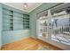 Inviting sunroom with ample natural light, built-in shelves, and a door to the outside at 231 Peachtree Ne Way, Atlanta, GA 30305