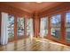 Charming sunroom with natural light, hardwood floors, and multiple windows that overlook the neighborhood at 231 Peachtree Ne Way, Atlanta, GA 30305