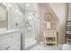 Modern bathroom featuring glass shower door and white vanity with gold fixtures at 487 Glendale Ct, Stone Mountain, GA 30087