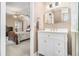 Bright bathroom featuring white vanity with updated gold fixtures and marble floors at 487 Glendale Ct, Stone Mountain, GA 30087
