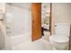 Bright bathroom featuring a shower over the tub with white tile and decorative floor at 487 Glendale Ct, Stone Mountain, GA 30087