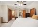 Bedroom featuring neutral carpeting, a ceiling fan, and a view to the en-suite at 487 Glendale Ct, Stone Mountain, GA 30087
