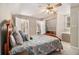 Comfortable bedroom with ceiling fan, soft carpet and a large bed with floral pattern bedding at 487 Glendale Ct, Stone Mountain, GA 30087