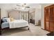 Bedroom with neutral carpeting, a ceiling fan, and closet with louvered doors at 487 Glendale Ct, Stone Mountain, GA 30087
