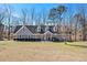 View of a cozy single-Gathering home featuring a well-manicured lawn, neat shrubbery, and a charming entrance at 487 Glendale Ct, Stone Mountain, GA 30087