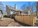 Charming two-story home featuring a large wooden deck, chimney, and fenced yard at 487 Glendale Ct, Stone Mountain, GA 30087
