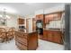 Kitchen and breakfast nook with wooden cabinetry, stainless steel appliances, and a chandelier at 487 Glendale Ct, Stone Mountain, GA 30087
