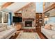 Cozy living room with a stone fireplace, wooden beams, and natural light at 487 Glendale Ct, Stone Mountain, GA 30087