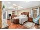 Spacious main bedroom with hardwood floors, a ceiling fan, and ample natural light at 487 Glendale Ct, Stone Mountain, GA 30087