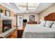 Cozy main bedroom featuring a fireplace, a ceiling fan, and hardwood flooring at 487 Glendale Ct, Stone Mountain, GA 30087