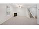 Open living room showcases a fireplace and staircase leading to the upper level at 1221 Rubble Road Rd, Cumming, GA 30040