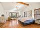 Bright main bedroom featuring hardwood floors, chandelier, bay windows, and ample natural light, creating a serene retreat at 400 Taylor Rd, Suwanee, GA 30024