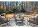 Outdoor patio area with furniture, grill, and serene wooded backdrop at 11120 Surrey Park Trail, Johns Creek, GA 30097