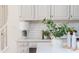 This bright kitchen features shaker cabinets, sleek counter tops, and marble subway tile backsplash at 11120 Surrey Park Trail, Johns Creek, GA 30097